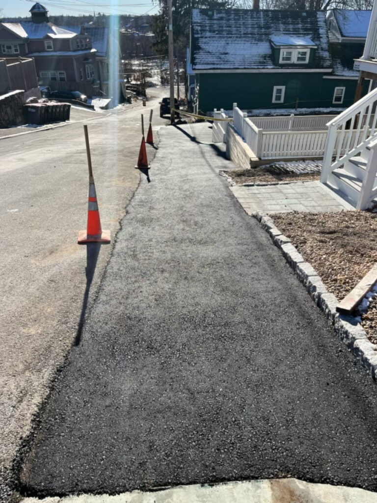 Northeast Contracting Solutions prepped, repaired, and paved this driveway and connecting areas for this property in Haverhill, MA. 